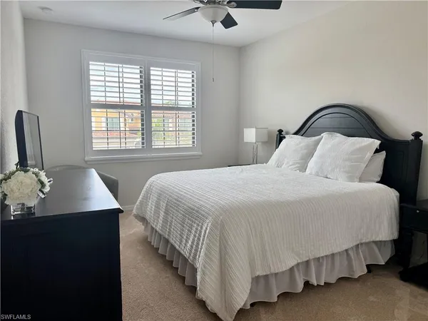 a bedroom with a bed and dresser