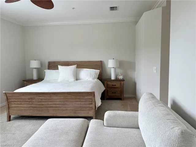 a bedroom with a bed and a couch