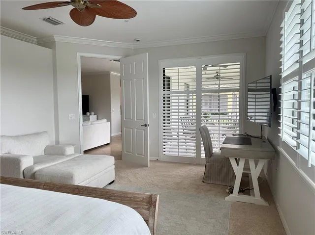 a bedroom with furniture and a large window
