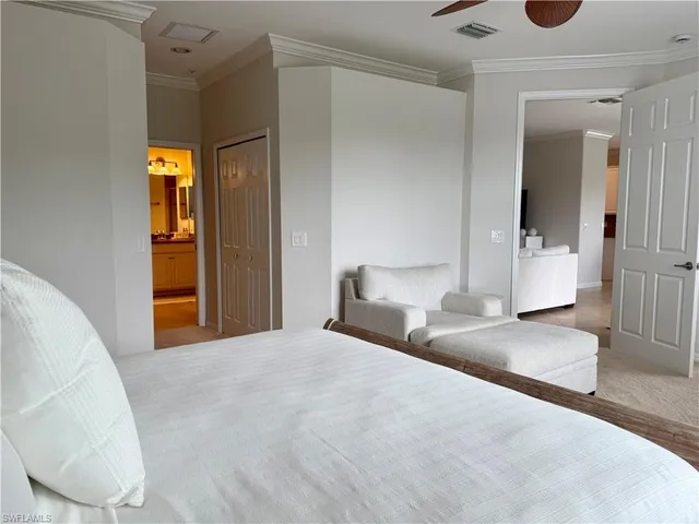 a bedroom with a bed and a large mirror