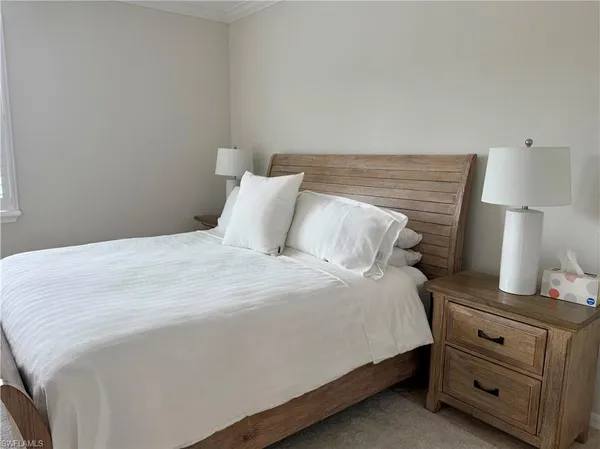 a bedroom with a bed and a lamp