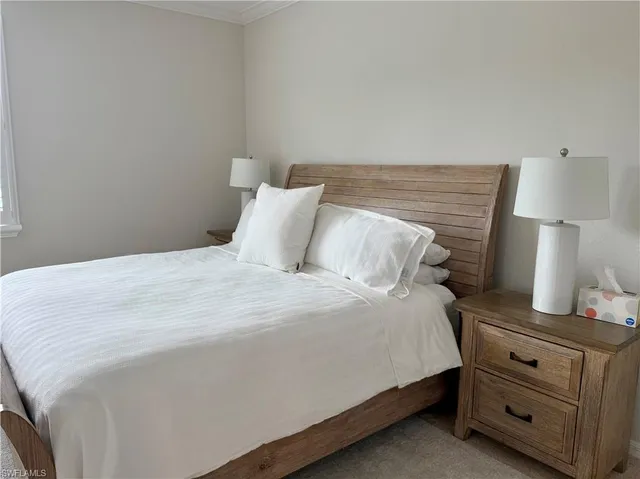 a bedroom with a bed and a lamp