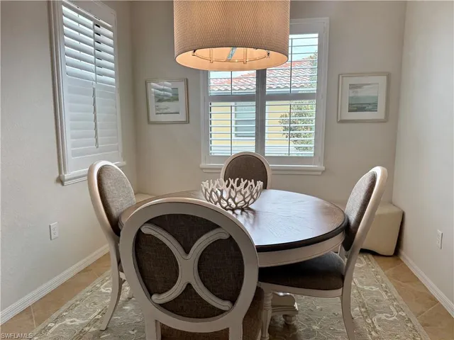 a dining room with furniture and window
