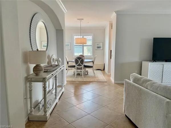 a living room with furniture a flat screen tv and a large window
