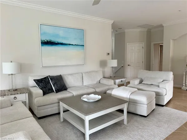 a living room with furniture and a night stand