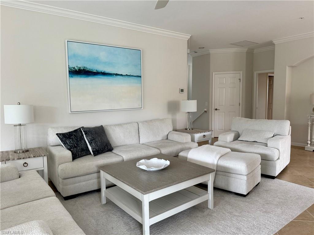 9498 Napoli Lane, Unit 201 Naples, FL 34113 - Photo 41 of 48 a living room with furniture and a night stand
