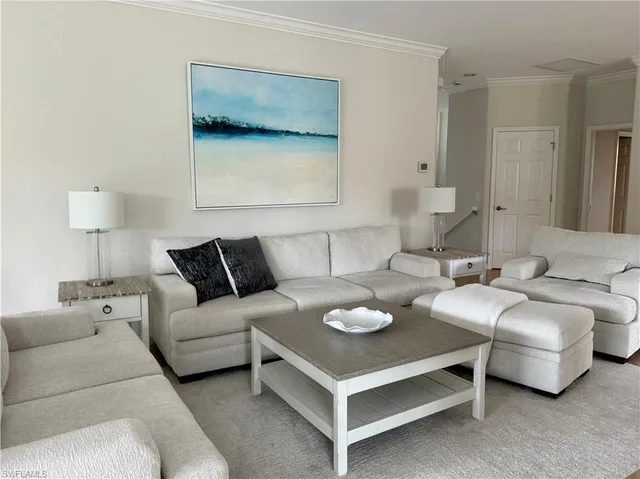 a living room with furniture and a lamp