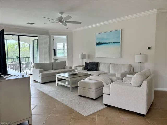 a living room with furniture and large windows