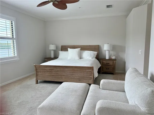 a bedroom with furniture and a large window