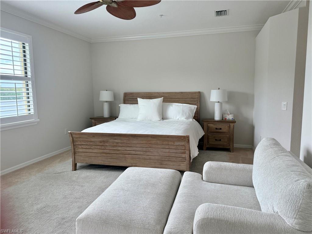 9498 Napoli Lane, Unit 201 Naples, FL 34113 - Photo 45 of 48 a bedroom with furniture and a large window