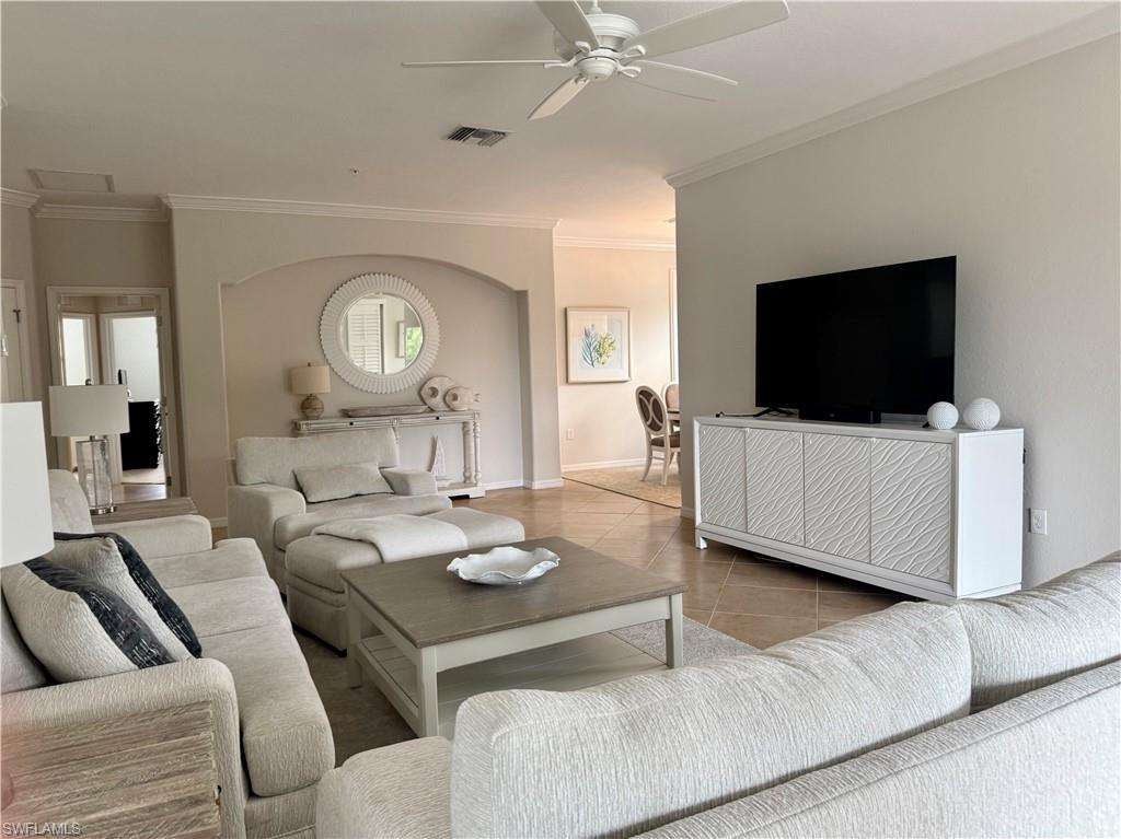 9498 Napoli Lane, Unit 201 Naples, FL 34113 - Photo 47 of 48 a living room with furniture and a flat screen tv