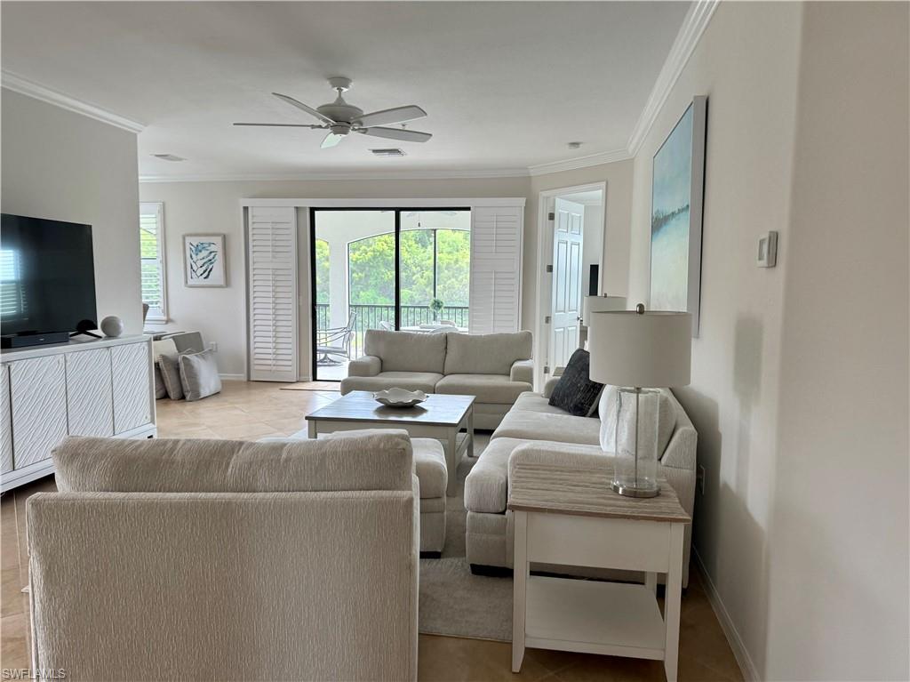 9498 Napoli Lane, Unit 201 Naples, FL 34113 - Photo 5 of 48 a living room with furniture and a flat screen tv