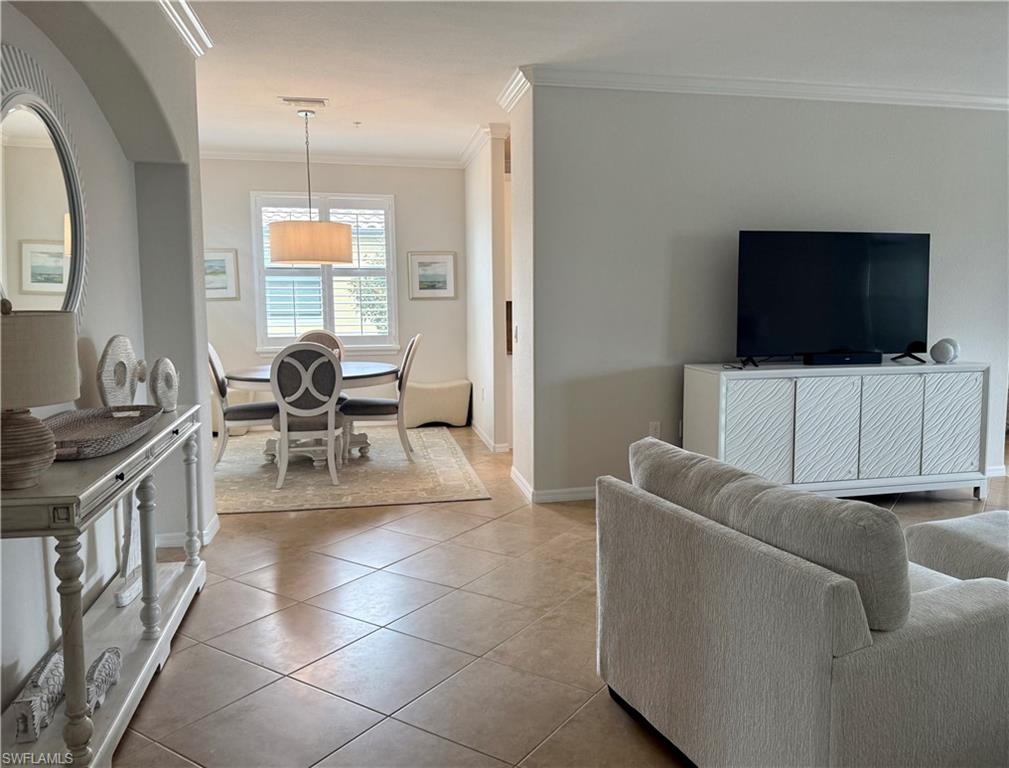9498 Napoli Lane, Unit 201 Naples, FL 34113 - Photo 6 of 48 a living room with furniture and a flat screen tv