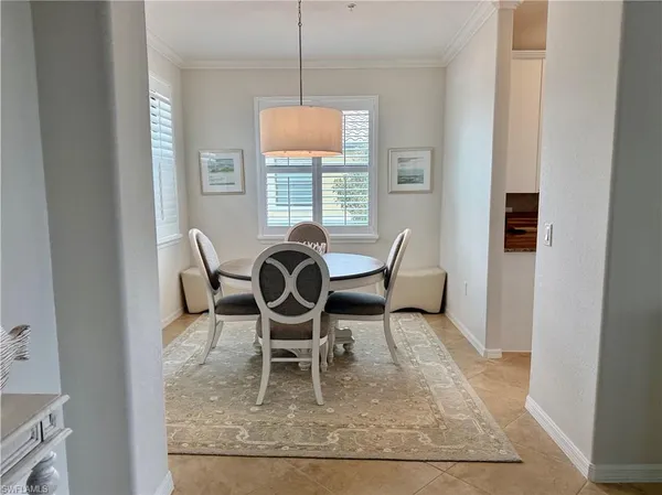 a dining room with furniture a rug and wooden floor