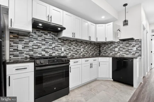a kitchen with stainless steel appliances granite countertop a stove and a sink