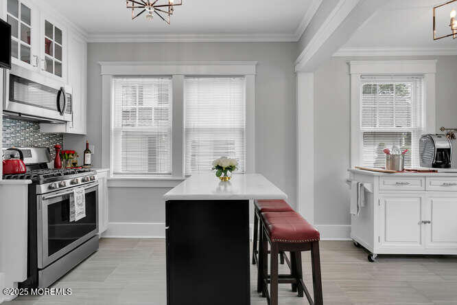 137 East Bergen Place Red Bank, NJ 07701 - Photo 11 of 40 a kitchen with a stove a sink and a refrigerator