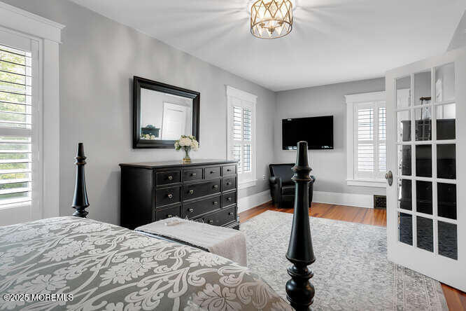 137 East Bergen Place Red Bank, NJ 07701 - Photo 18 of 40 a bedroom with a bed and a flat tv screen in it