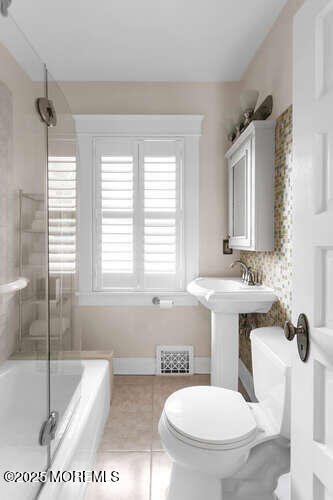 137 East Bergen Place Red Bank, NJ 07701 - Photo 23 of 40 a bathroom with a toilet sink and mirror