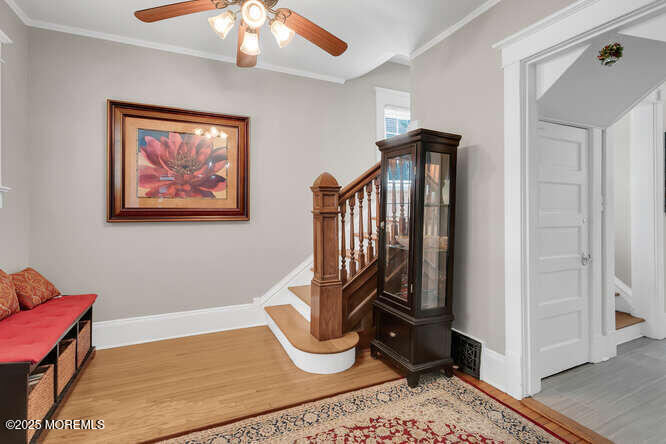 137 East Bergen Place Red Bank, NJ 07701 - Photo 3 of 40 a view of a hallway with wooden floor and a potted plant