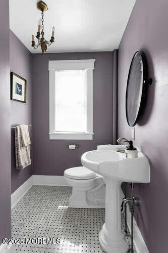 137 East Bergen Place Red Bank, NJ 07701 - Photo 10 of 40 a bathroom with a toilet a sink and a mirror