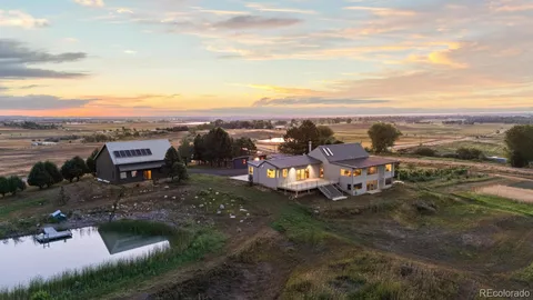 an aerial view of a house with a lake view