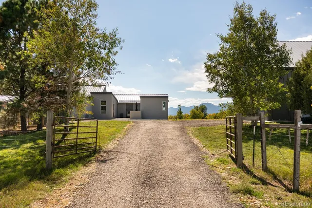 a view of a house with swimming pool and sitting area