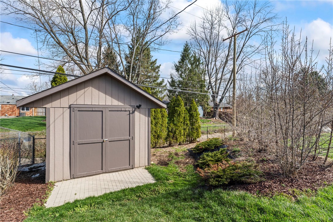 2247 East Whipp Road Dayton, OH 45440 - Photo 50 of 52 This charming backyard shed offers practical storage amidst a serene outdoor setting.