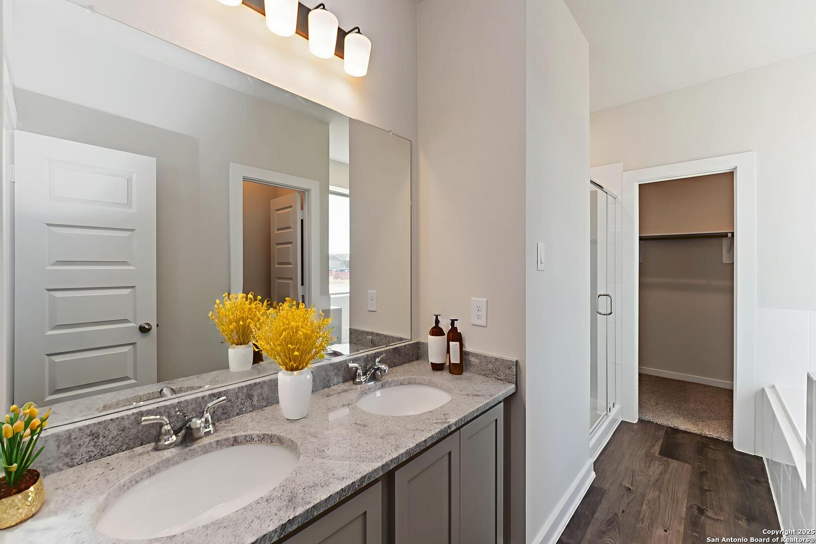 8922 Hazel Birch Elmendorf, TX 78112 - Photo 5 of 7 a bathroom with a granite countertop sink and a mirror