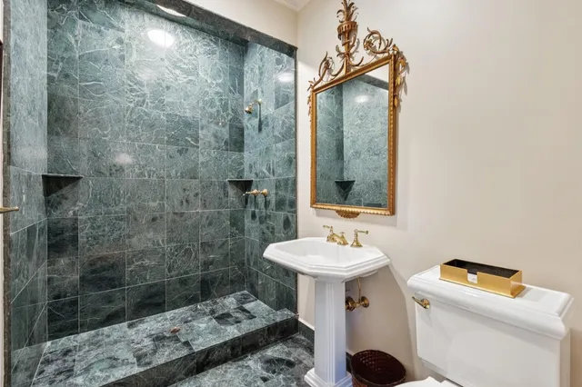 a view of staircase with lots of frames on wall and a window