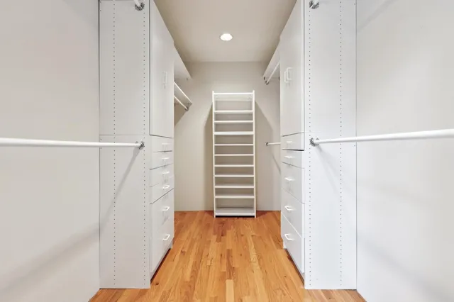 a bathroom with a granite countertop tub sink and mirror