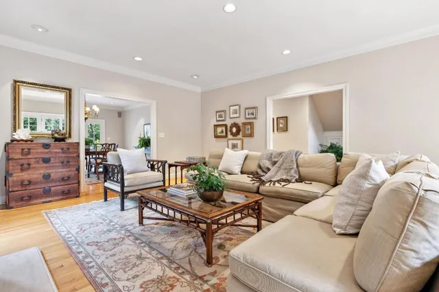 a living room with furniture a fireplace and a floor to ceiling window