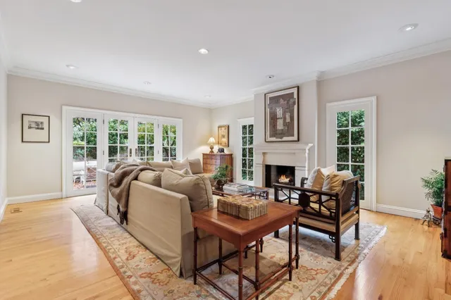 a living room with furniture a fireplace and a table
