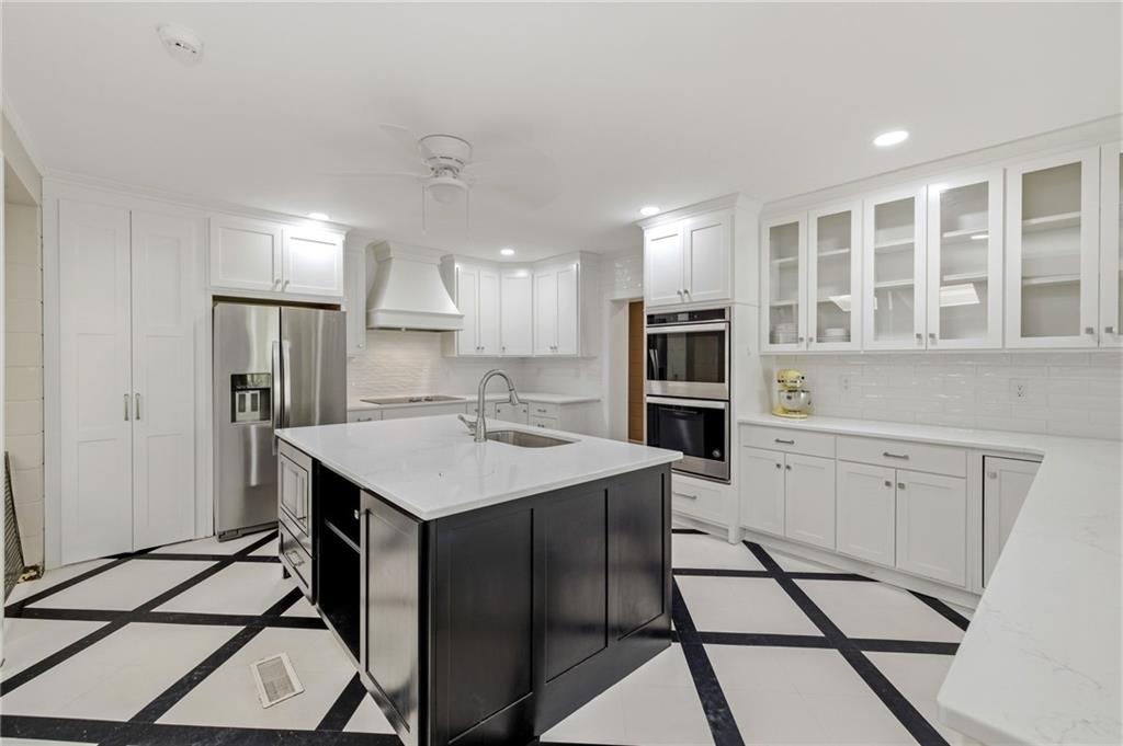 490 Maple Street Cornelia, GA 30531 - Photo 12 of 88 a kitchen with a stove a refrigerator and cabinets