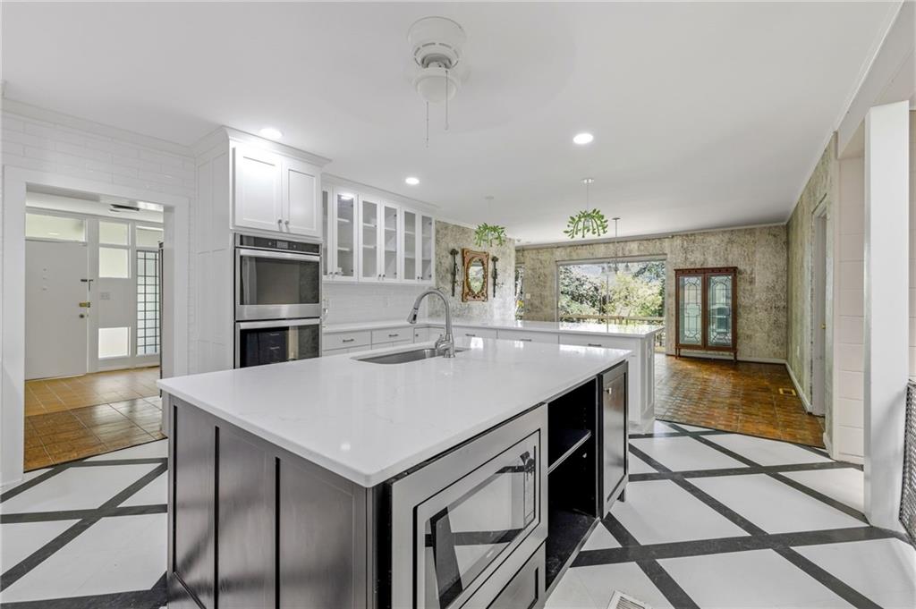 490 Maple Street Cornelia, GA 30531 - Photo 15 of 88 a kitchen with kitchen island a sink stove and refrigerator
