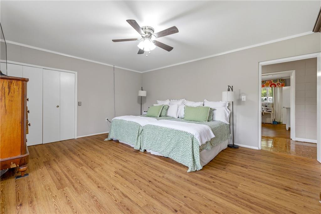 490 Maple Street Cornelia, GA 30531 - Photo 22 of 88 a bedroom with a large bed and a chandelier