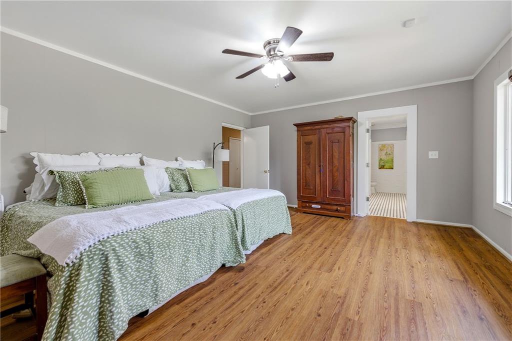 490 Maple Street Cornelia, GA 30531 - Photo 23 of 88 a spacious bedroom with a bed and a chandelier