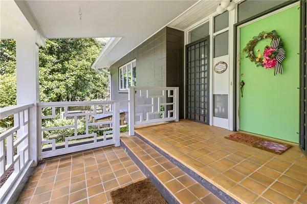 a view of an empty room with glass door and a window