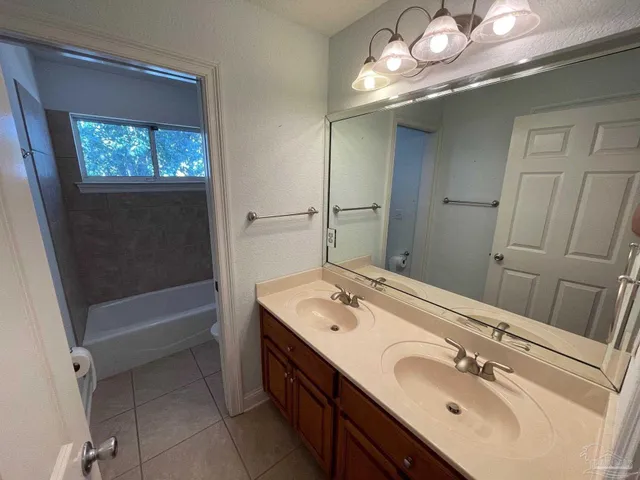 a bathroom with a sink double vanity and a mirror