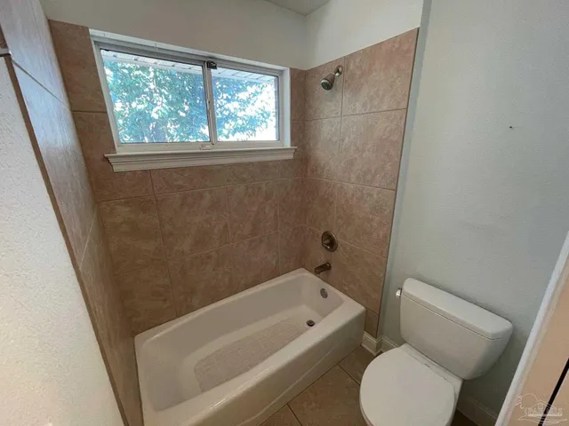 a bathroom with a toilet and a bathtub