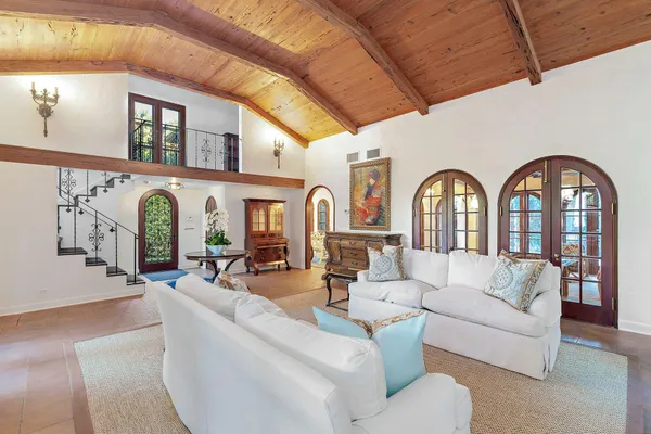 a living room with furniture fireplace and a large window