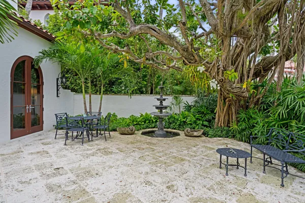 a view of a patio with table and chairs and potted plants