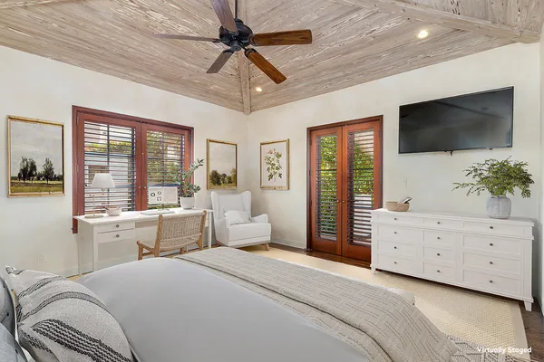 a room with a bed a flat screen tv and a window