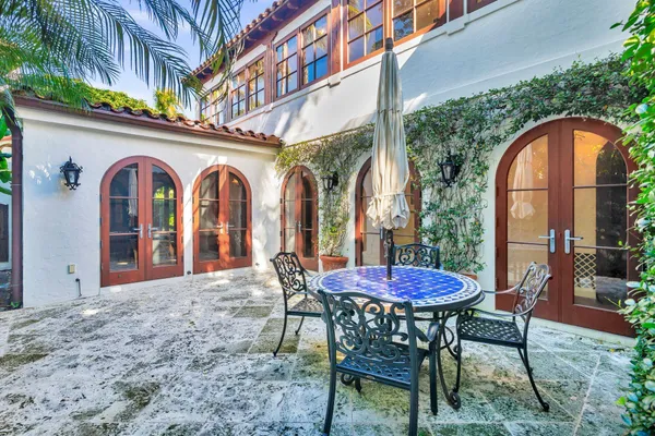 a view of a chairs and table in the patio