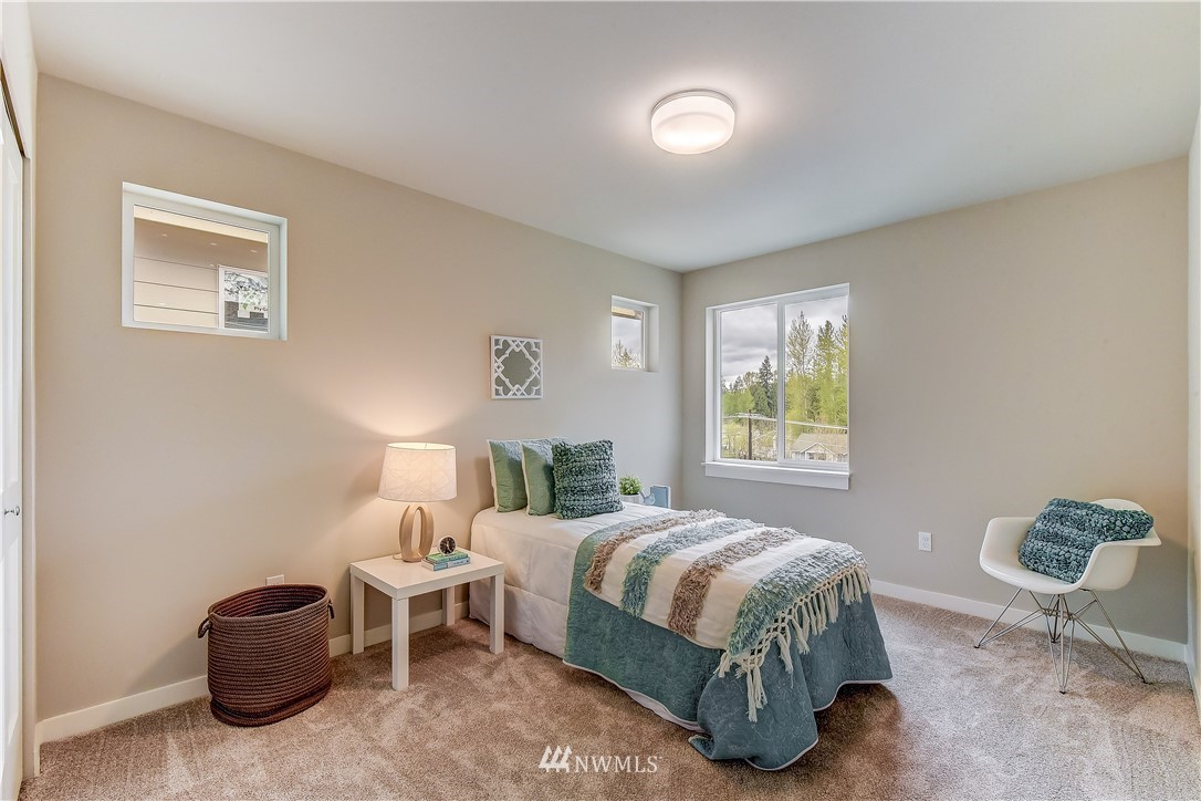 22827 23rd Avenue Southeast, Unit 7 Bothell, WA 98021 - Photo 15 of 19 a bedroom with a bed and a window