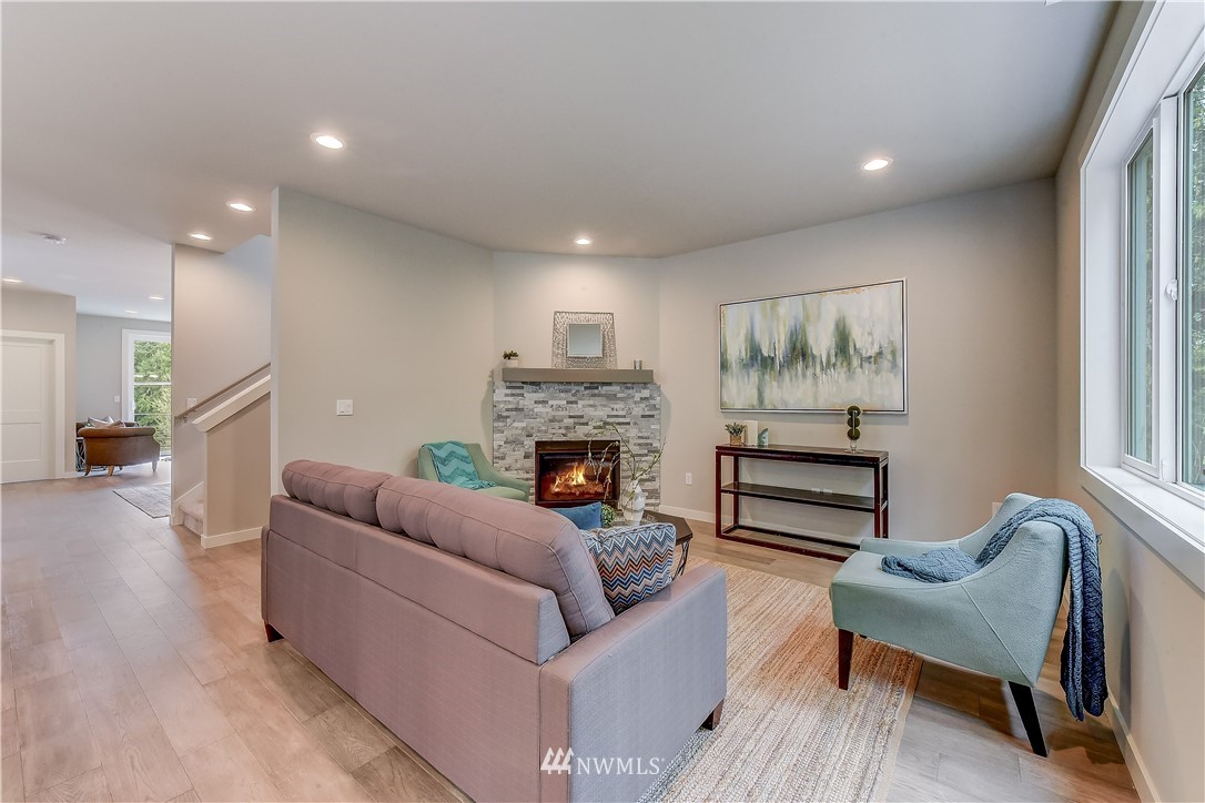 22827 23rd Avenue Southeast, Unit 7 Bothell, WA 98021 - Photo 8 of 19 a living room with furniture and a fireplace