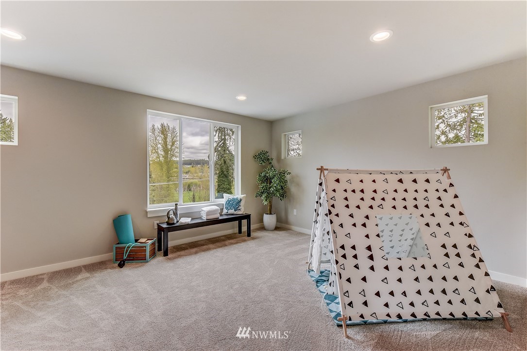 22827 23rd Avenue Southeast, Unit 7 Bothell, WA 98021 - Photo 9 of 19 a living room with a large window and a couch