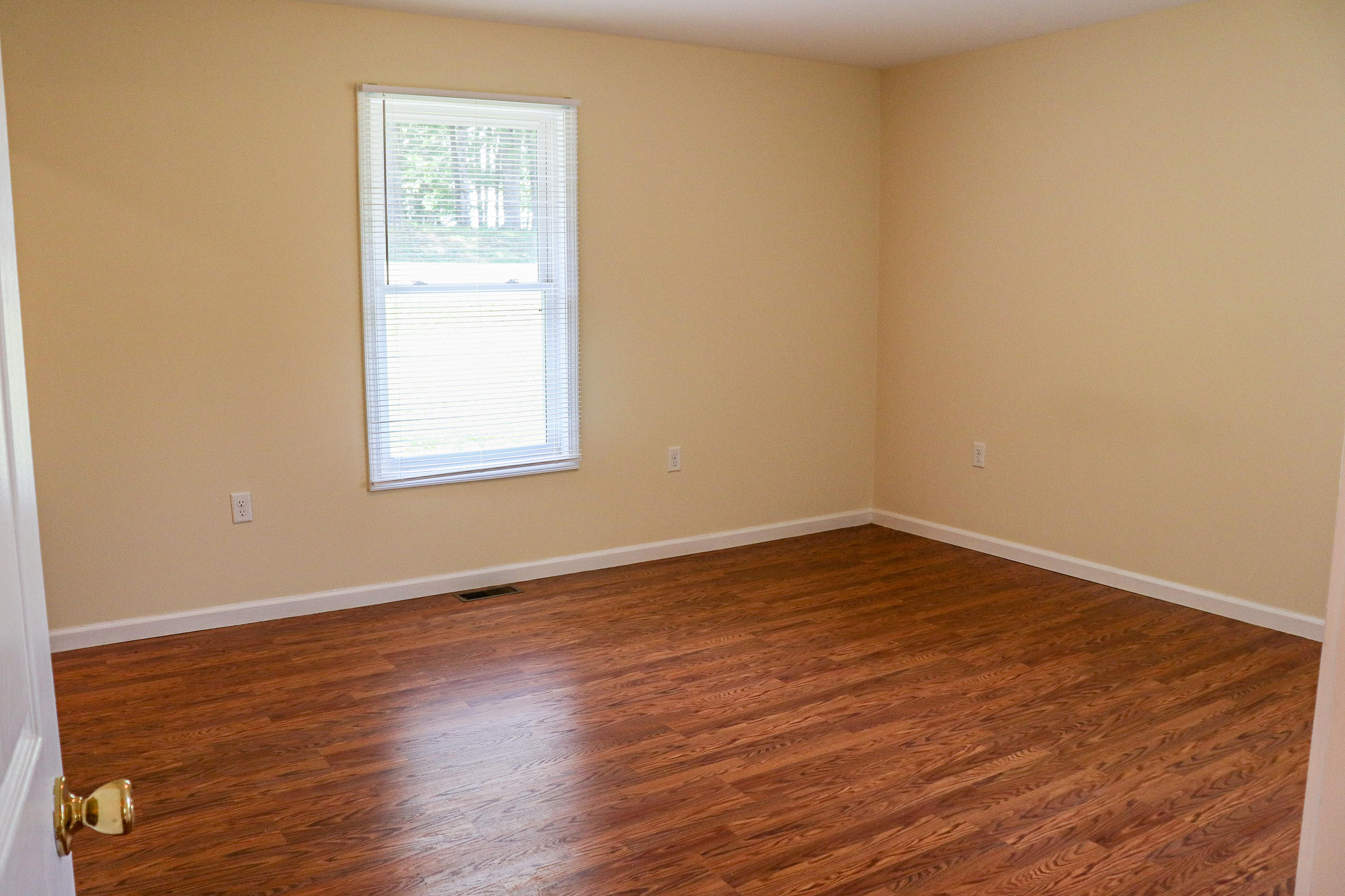 729 Huffville Road Northeast Pilot, VA 24138 - Photo 7 of 13 an empty room with wooden floor and windows
