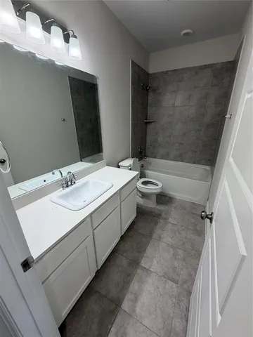 a bathroom with a double vanity sink toilet mirror and shower