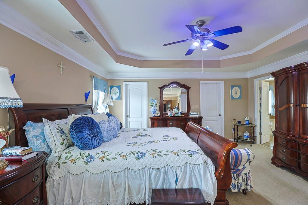 300 Hampton Place Canton, GA 30115 - Photo 59 of 82 a bedroom with a bed and a mirror on dresser