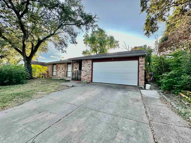 a view of a house with a yard and garage
